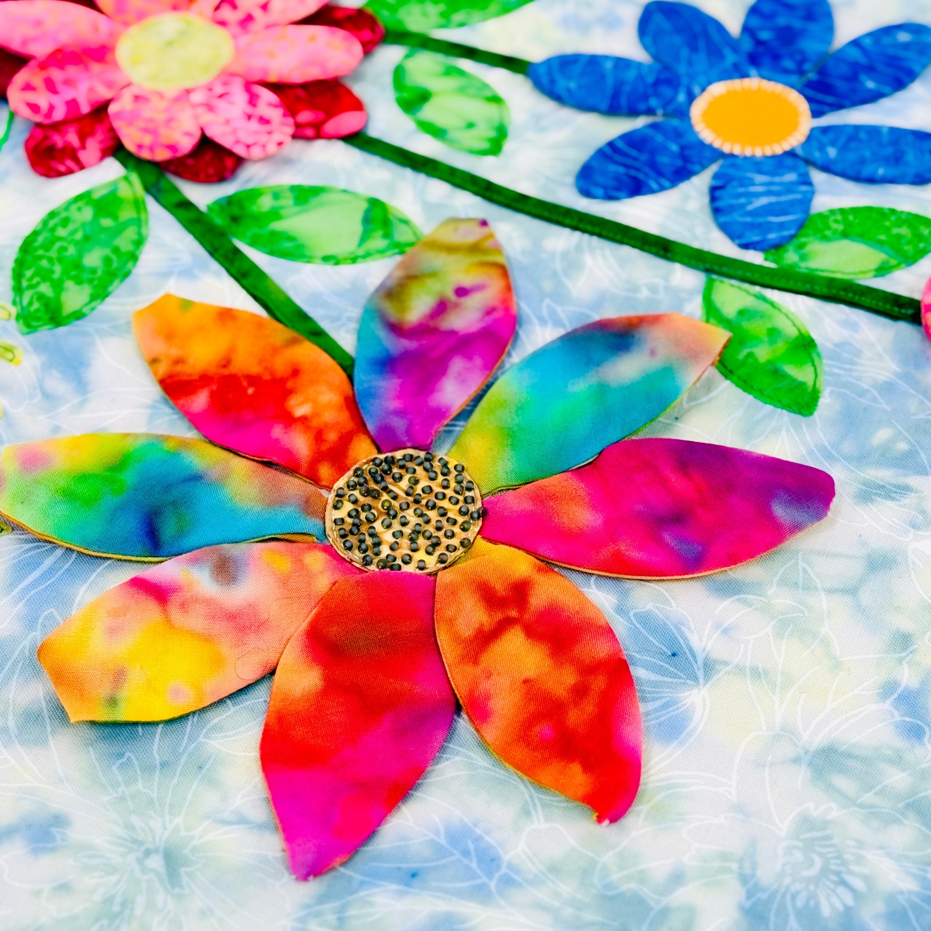 Colorful flower-shaped art pieces on a textured white background