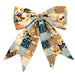 A large fabric bow featuring a patchwork design with gingham, floral, and pumpkin motifs in navy blue, beige, brown, and light blue, photographed on a solid white background.