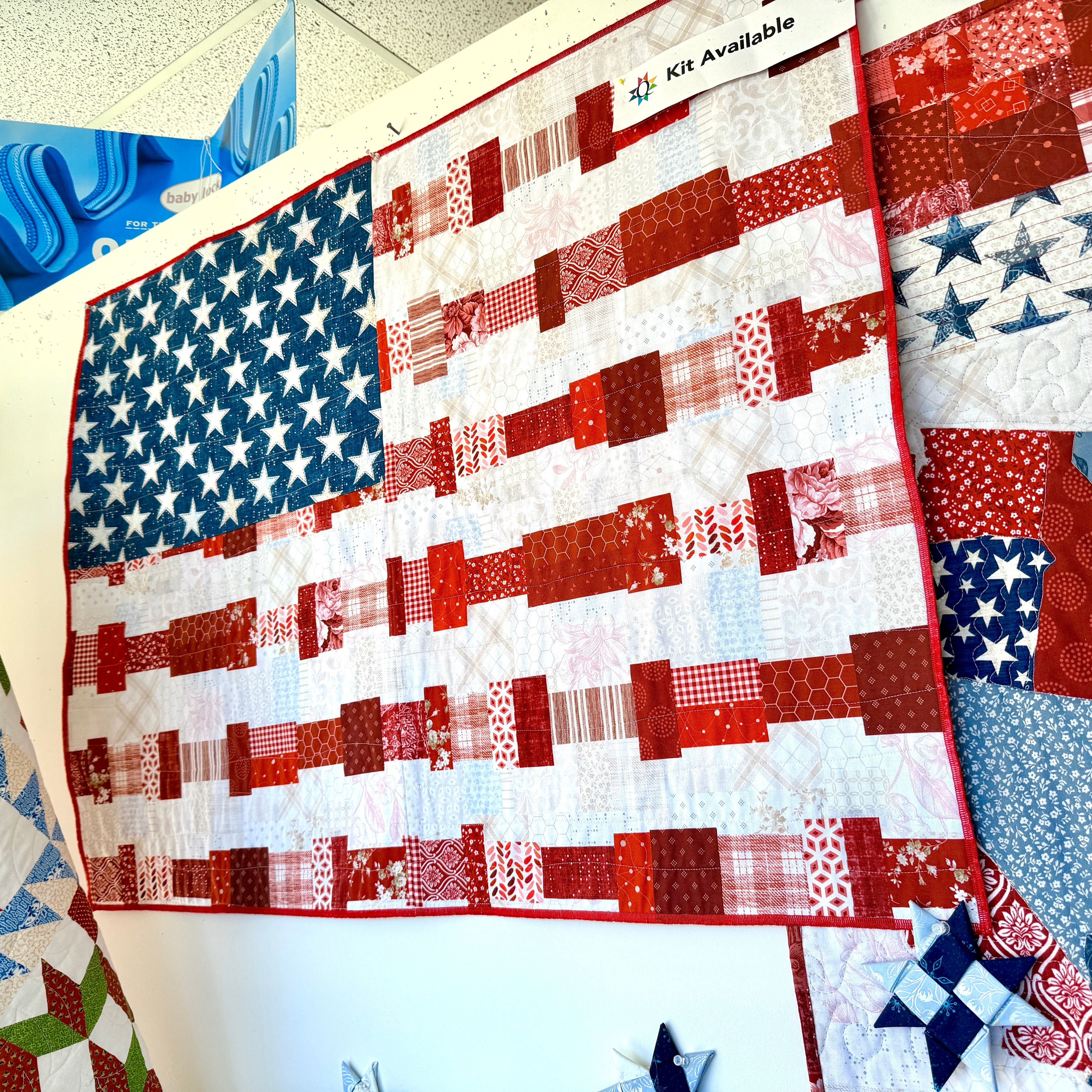 Quilt with American flag pattern displayed on a table.