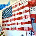 Quilt with American flag pattern displayed on a table.