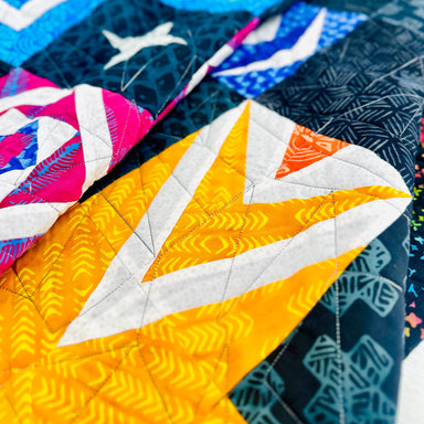 Close-up of a colorful quilt with geometric patterns