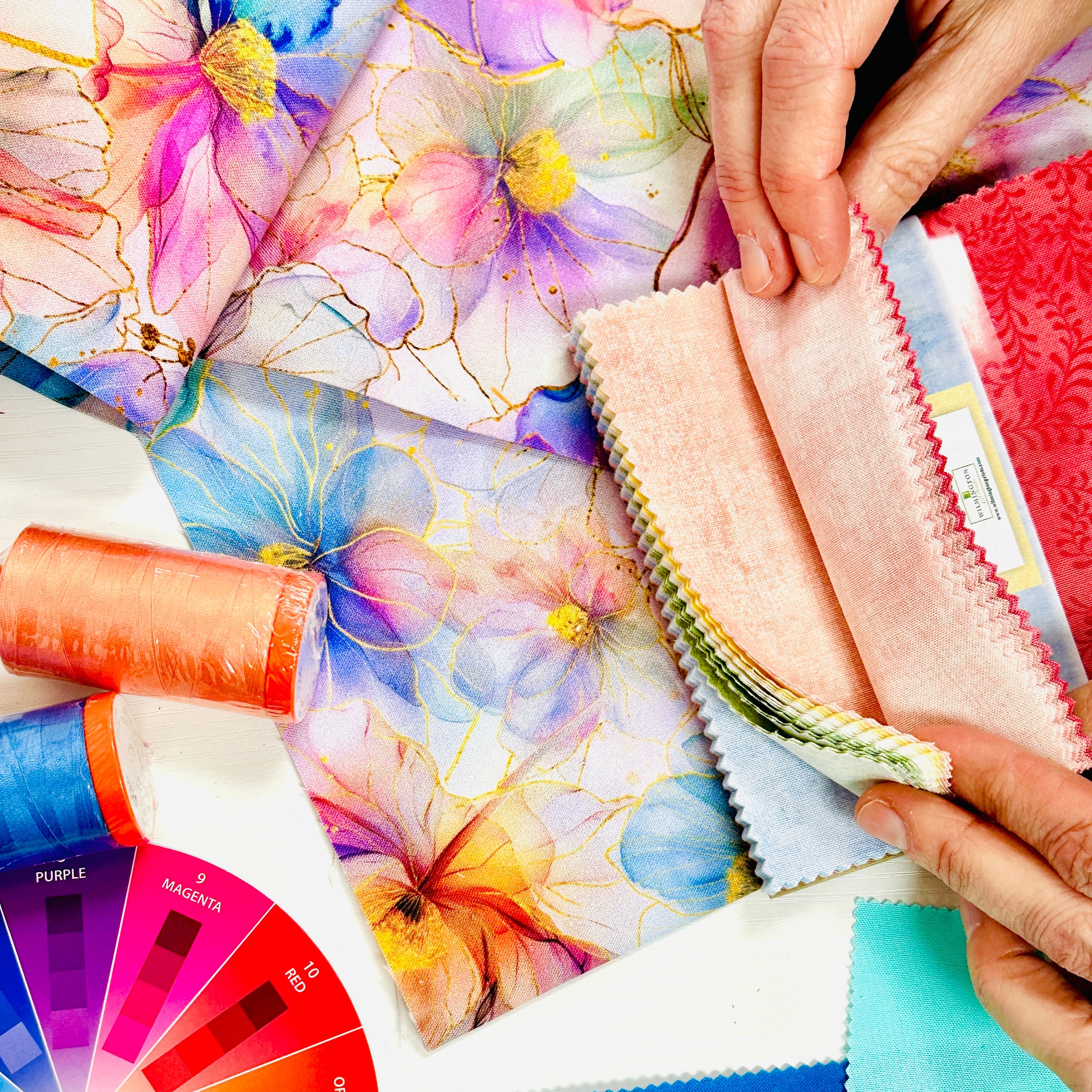 Color swatches and fabric samples with a color wheel on a table