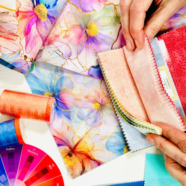 Color swatches and fabric samples with a color wheel on a table