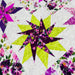 A close-up of a colorful quilted fabric featuring geometric star and floral block patterns in purple, pink, lime green, and white.
