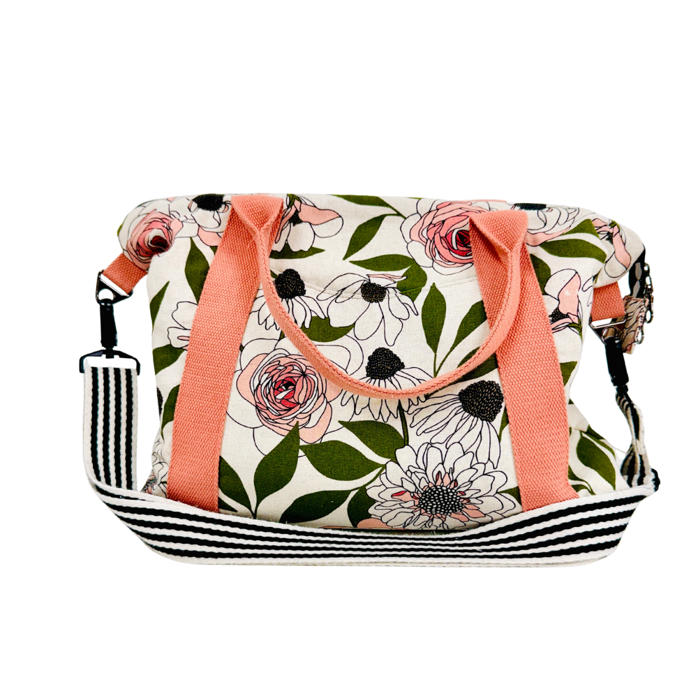 Floral patterned bag with pink straps on a white background