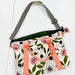 Floral-patterned bag with pink straps on a white background