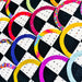 A close-up of a colorful quilted fabric pattern featuring alternating black and white checkered squares with curved semicircle arcs in bright pink, yellow, blue, purple, green, and orange, some with floral or textured prints.