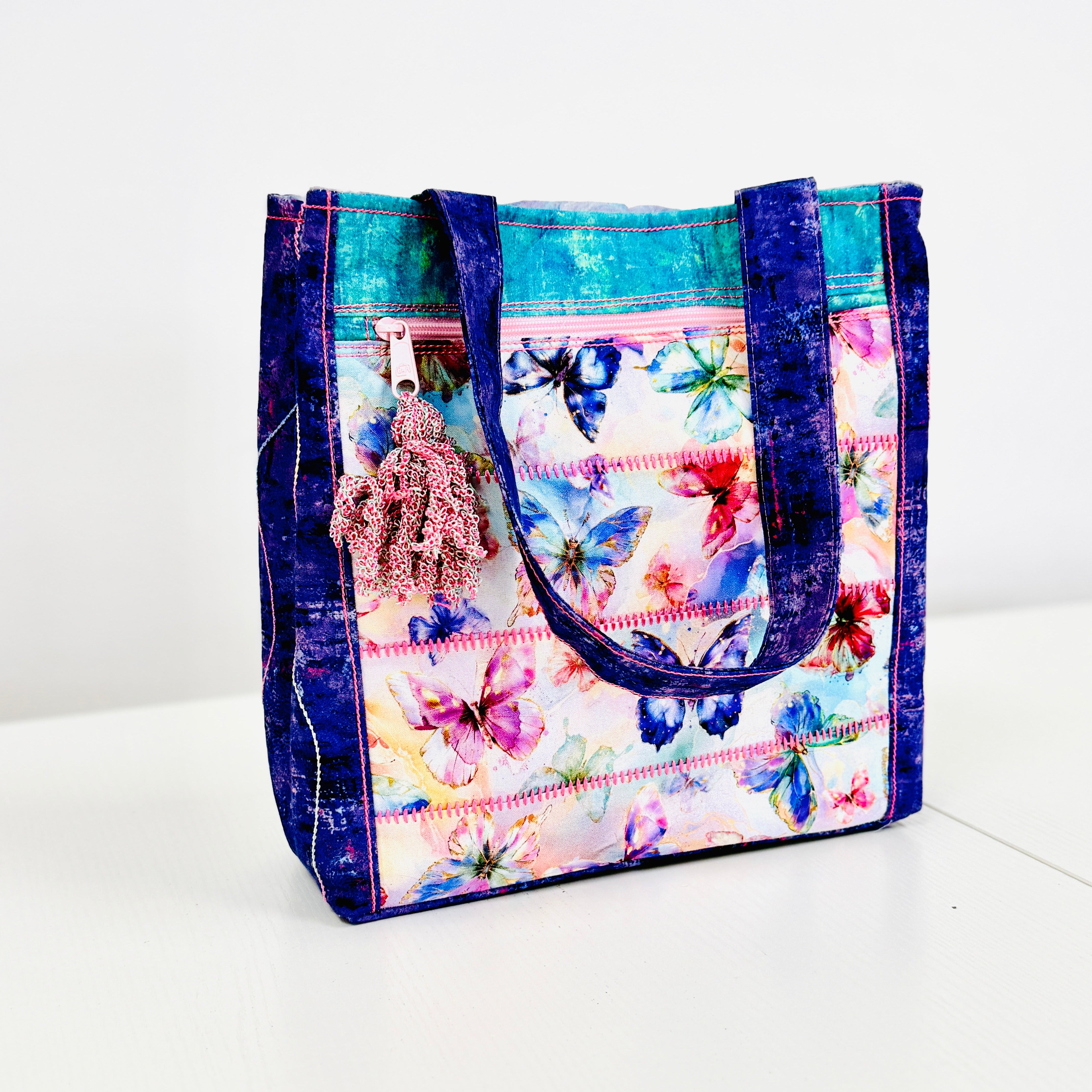 Colorful tote bag with butterfly pattern on a white background