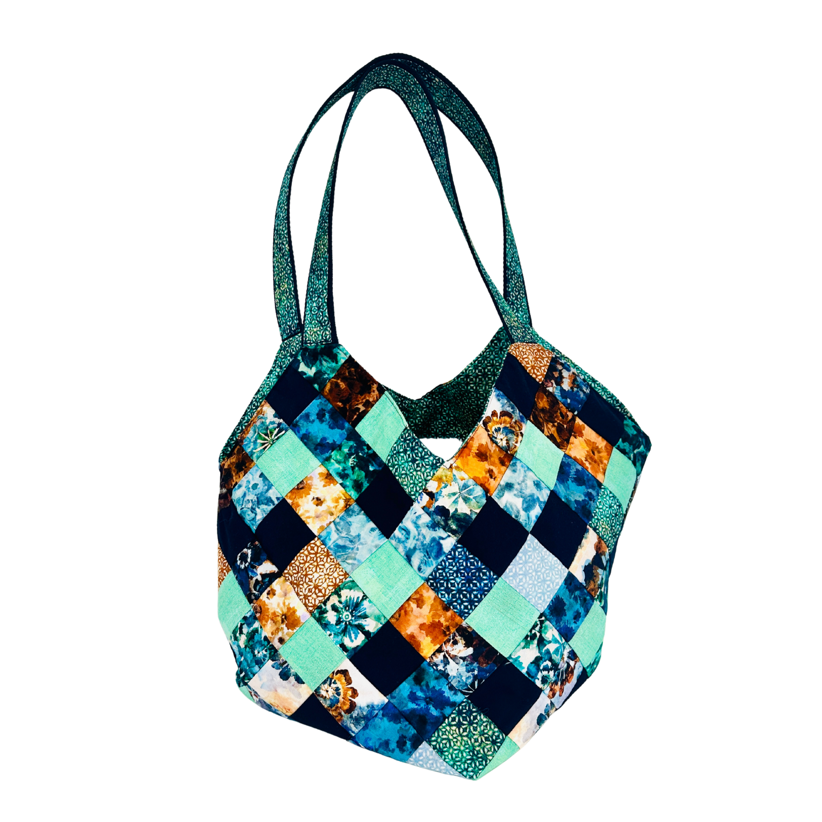 Colorful patchwork handbag with floral patterns on a white background