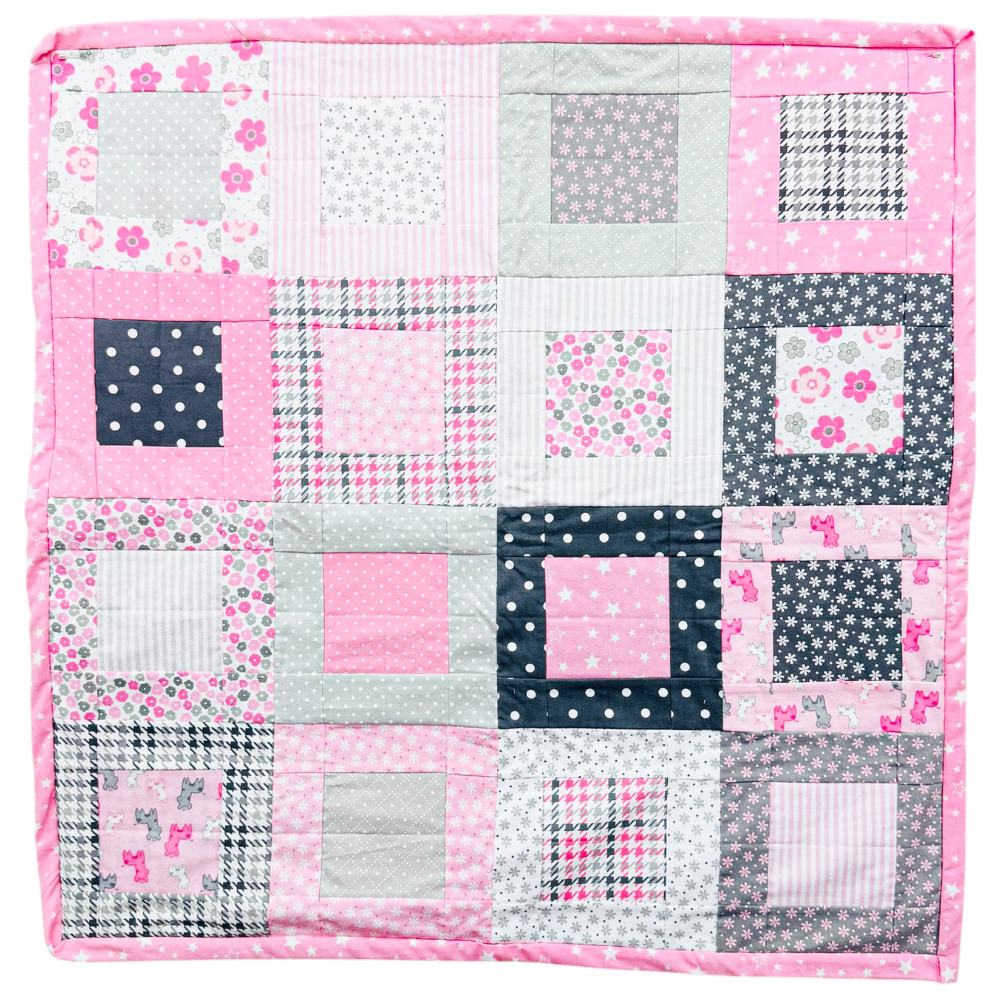 A square patchwork quilt featuring a variety of pink, gray, and navy blue fabrics with floral, polka dot, plaid, and striped patterns, finished with a solid pink border.
