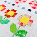Colorful quilt with geometric patterns on a white background