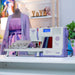 Sewing machine on a table with a blurred background featuring a person and colorful items.