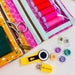 Sewing kit with colorful thread spools, scissors, and other tools on a white background