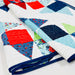 Colorful quilt with geometric patterns on a white background